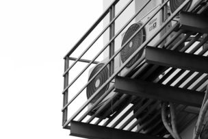 a black and white photo of a clock on a building